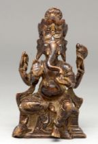 An Indian bronze sculpture of Ganesha, 17th - 18th c, with silver eyes, 16cm h Complete and intact