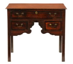 A George III oak and crossbanded lowboy, with three cockbeaded drawers to the unusually arched