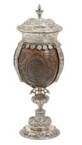 An Edwardian silver mounted French coconut cup and cover, 18th/19th c, carved with three oval