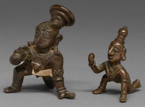 An Indian bronze statuette of a crawling Balakrishna, 18th c, 77mm h and another, similar, smaller