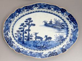 A Chinese blue and white dish, 18th c, painted with a river scene with two prominent antelope and