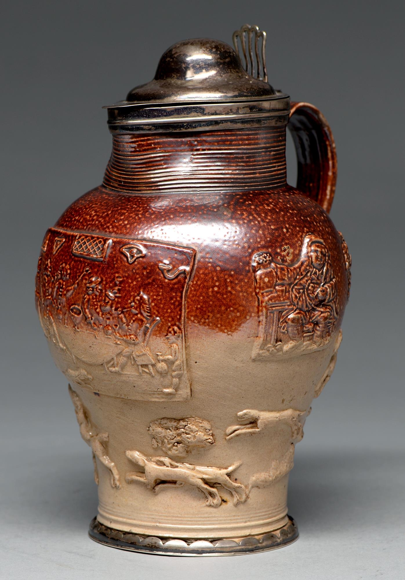 A silver mounted Mortlake saltglazed brown stoneware hunting jug, c1790, the sprigged decoration