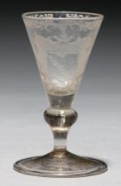 A German wine glass, 18th c, the conical bowl engraved with shield of arms beneath strapwork