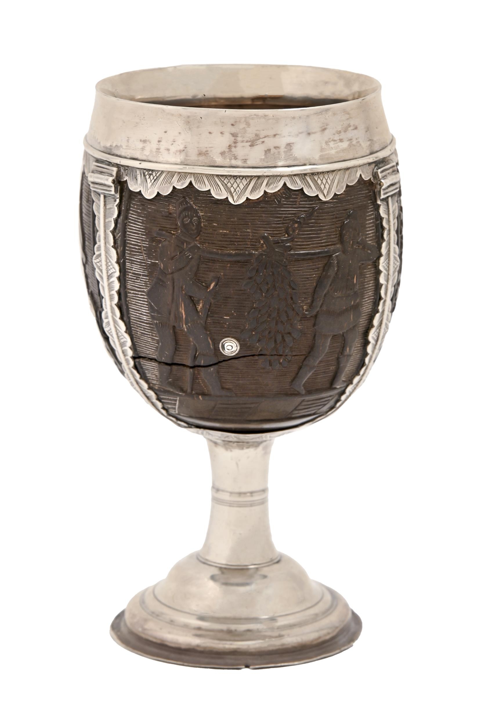 An English silver mounted coconut cup, late 17th/early 18th c, carved with a flag bearer, seated man