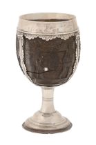 An English silver mounted coconut cup, late 17th/early 18th c, carved with a flag bearer, seated man