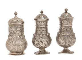 One and a pair of Indian silver pepperettes, 19th / early 20th c, decorated with flowers and