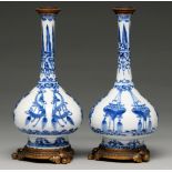 A pair of Chinese blue and white bottle vases, Kangxi period, on flared foot, painted to the central
