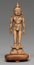 An Indian carved bone miniature devotional statuette, possibly 16th / 17th c, 11.5cm h, affixed