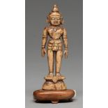 An Indian carved bone miniature devotional statuette, possibly 16th / 17th c, 11.5cm h, affixed