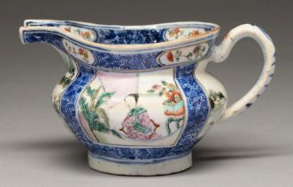 A Chinese underglaze blue and famille rose milk jug, early 19th c, enamelled with square panels of a