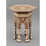 A Middle Eastern ivory-inlaid miniature hexagonal table, Egypt or Syria, late 19th c, with geometric