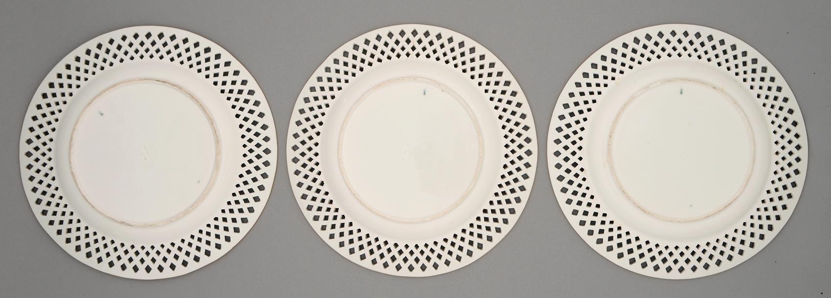 A set of three Minton plates, c1870, painted to the centre with a Continental landscape encircled by - Image 2 of 3