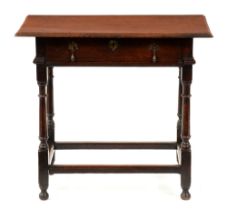 A George II oak side table, the over-sailing two plank top with moulded lip, on turned legs united