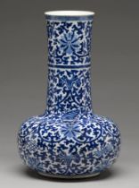 A Chinese blue and white bottle shaped vase, 20th c, painted in Ming style with lotus meander,