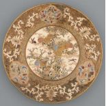 A Satsuma ware plate, Meiji period, enamelled and gilt with chrysanthemums and insects in wide