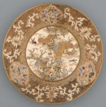 A Satsuma ware plate, Meiji period, enamelled and gilt with chrysanthemums and insects in wide