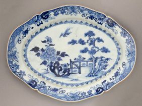 A Chinese blue and white dish, 18th / early 19th c, painted with a pine tree and tree peony before a