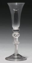 An ale glass, mid 18th c, the bucket bowl on multiple spiral air twist stem with shoulder and centre