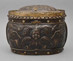 A French cuir bouilli box, 18th c, of oval shape with scalloped and rivetted brass mounts and