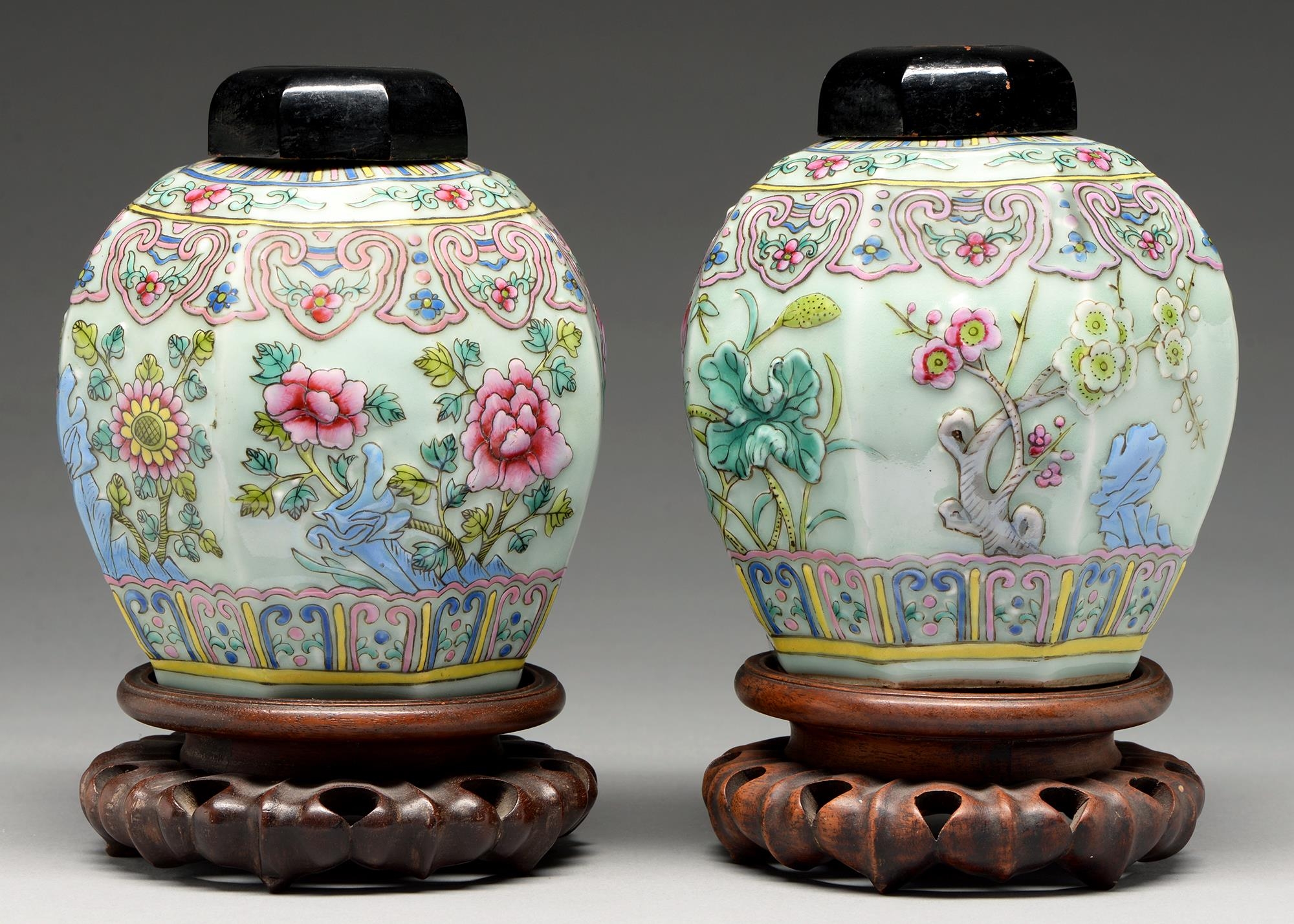 A pair of Chinese celadon ground famille rose moulded octagonal jars, 20th c, decorated with