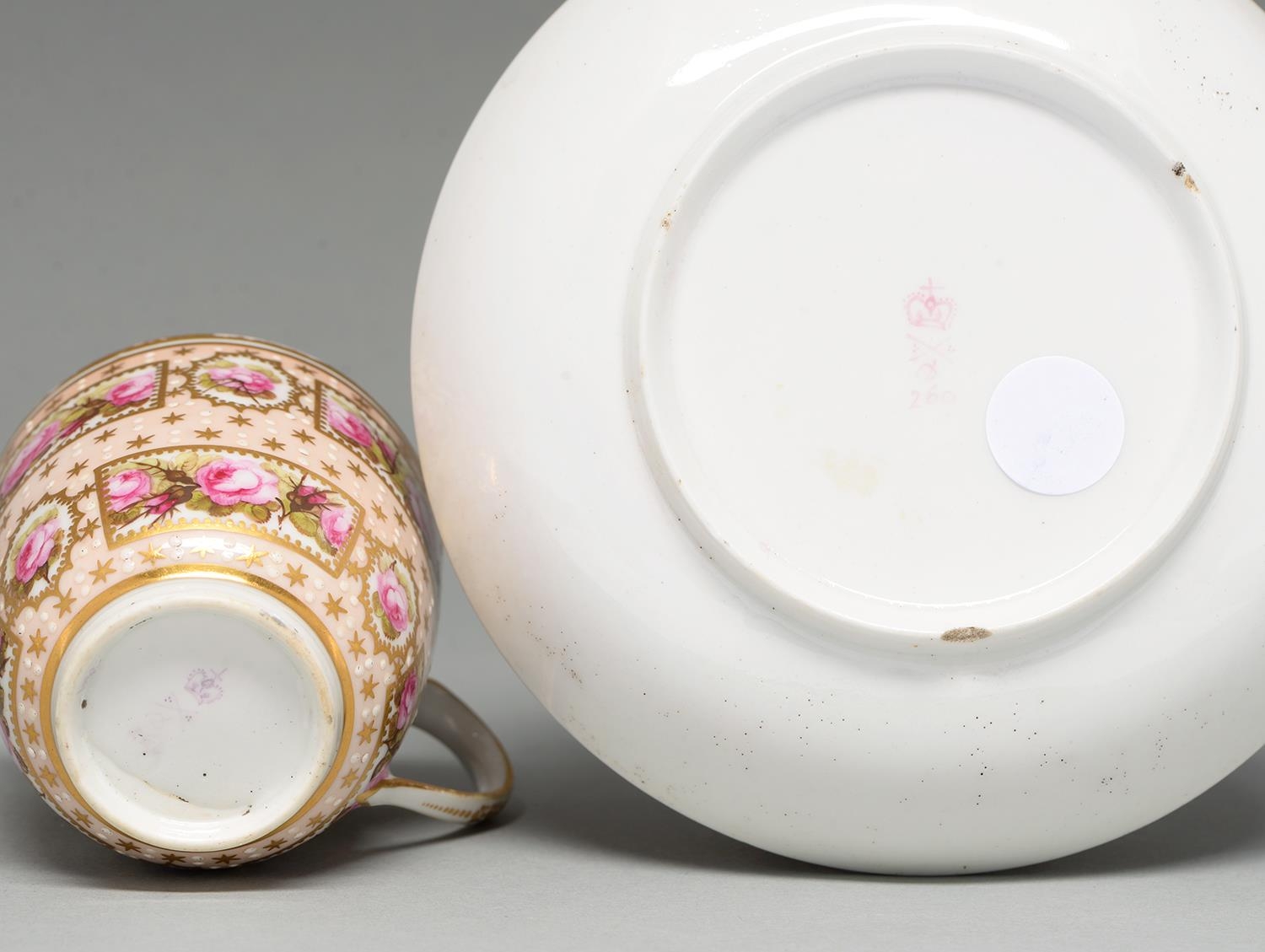 A Derby coffee cup and saucer, c1795, painted with reserves of roses on a salmon pink ground, saucer - Image 2 of 2