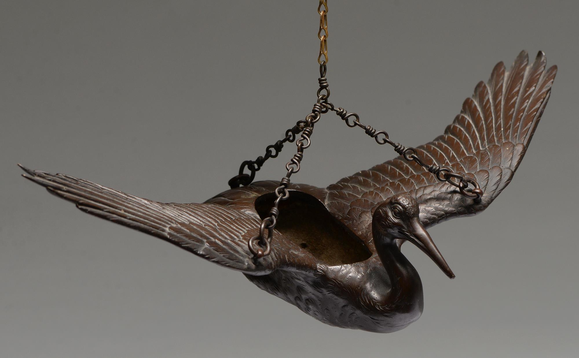 A Japanese bronze hanging sculpture of a flying crane, for flower arrangement, Meiji period, 33.