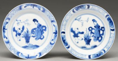 A pair of Chinese blue and white miniature plates, Kangxi period, painted with a woman and jumping