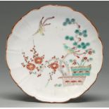 A Chinese fluted saucer with Kakiemon-style decoration, 18th c, enamelled with a prunus and pine