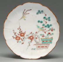 A Chinese fluted saucer with Kakiemon-style decoration, 18th c, enamelled with a prunus and pine