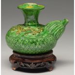 A Chinese green glazed biscuit kendi, Ming dynasty, the shoulder moulded with dragons, the flared