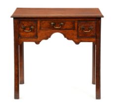 A George III oak lowboy, with three cockbeaded drawers to the arched apron, on chamfered legs,