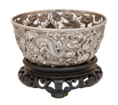 A Chinese silver pierced repousse bowl, c1900, chased with dragons and clouds, 13cm diam, maker's