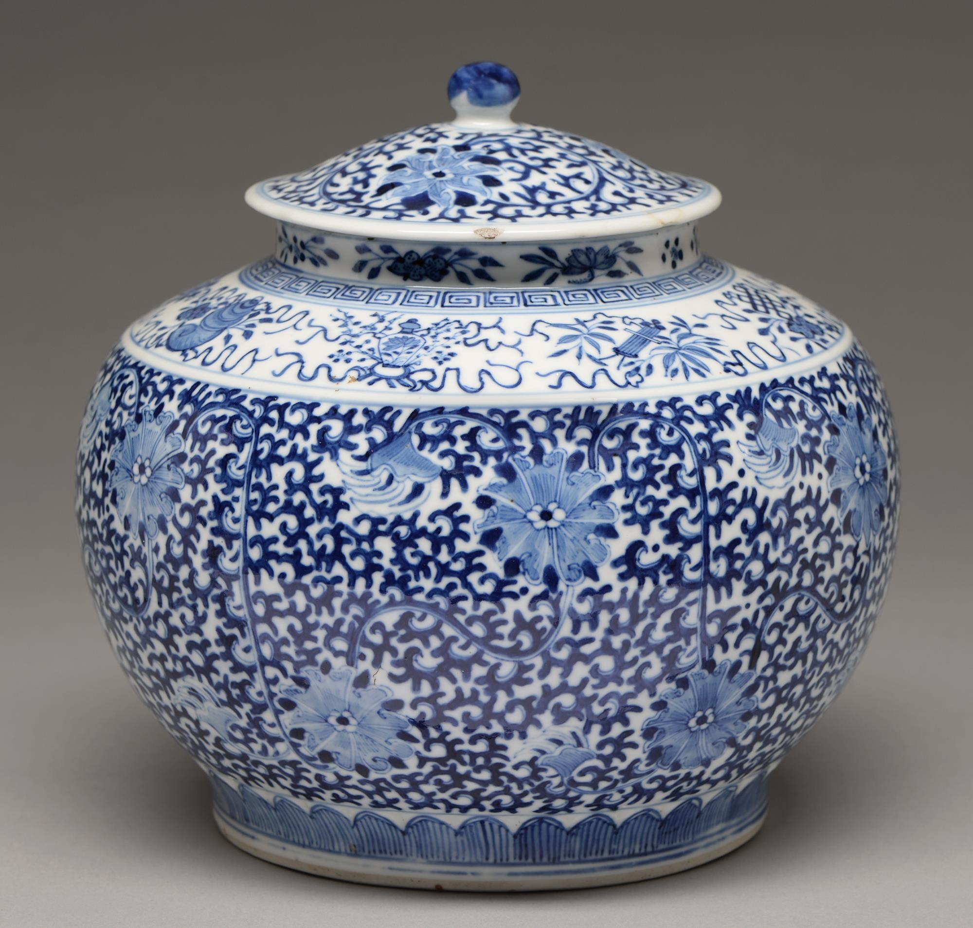 A Chinese blue and white jar and cover, late 19th c or later, painted with lotus and classic scroll,
