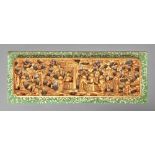 A Chinese carved and pierced gilt lacquered wood relief, 20th c, in painted green and mother of