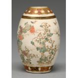 A Satsuma ware drum shaped vase, Meiji period, enamelled and gilt with naturalistic flowering plants