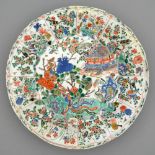 A Chinese famille verte dish, Kangxi period, enamelled with temple, phoenix, cranes and flowering
