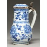 A Chinese blue and white jug, 18th c, painted in two registers with peonies between diaper
