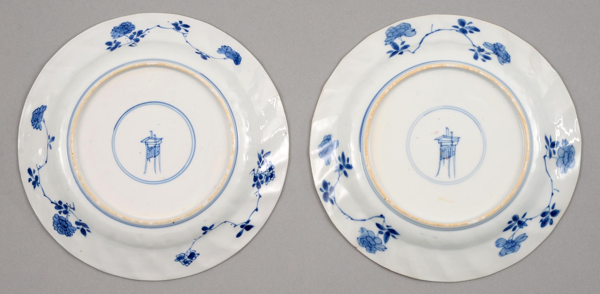 A pair of Chinese blue and white plates, Kangxi period, painted with peonies and other plants, the - Image 2 of 2