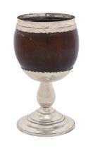 A silver mounted coconut cup, 18th in scalloped mounts on baluster stem and domed foot, 17cm h,