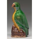 A Chinese glazed biscuit model of a hawk, 19th c, the bird with black eye and glazed in green and