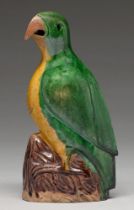 A Chinese glazed biscuit model of a hawk, 19th c, the bird with black eye and glazed in green and