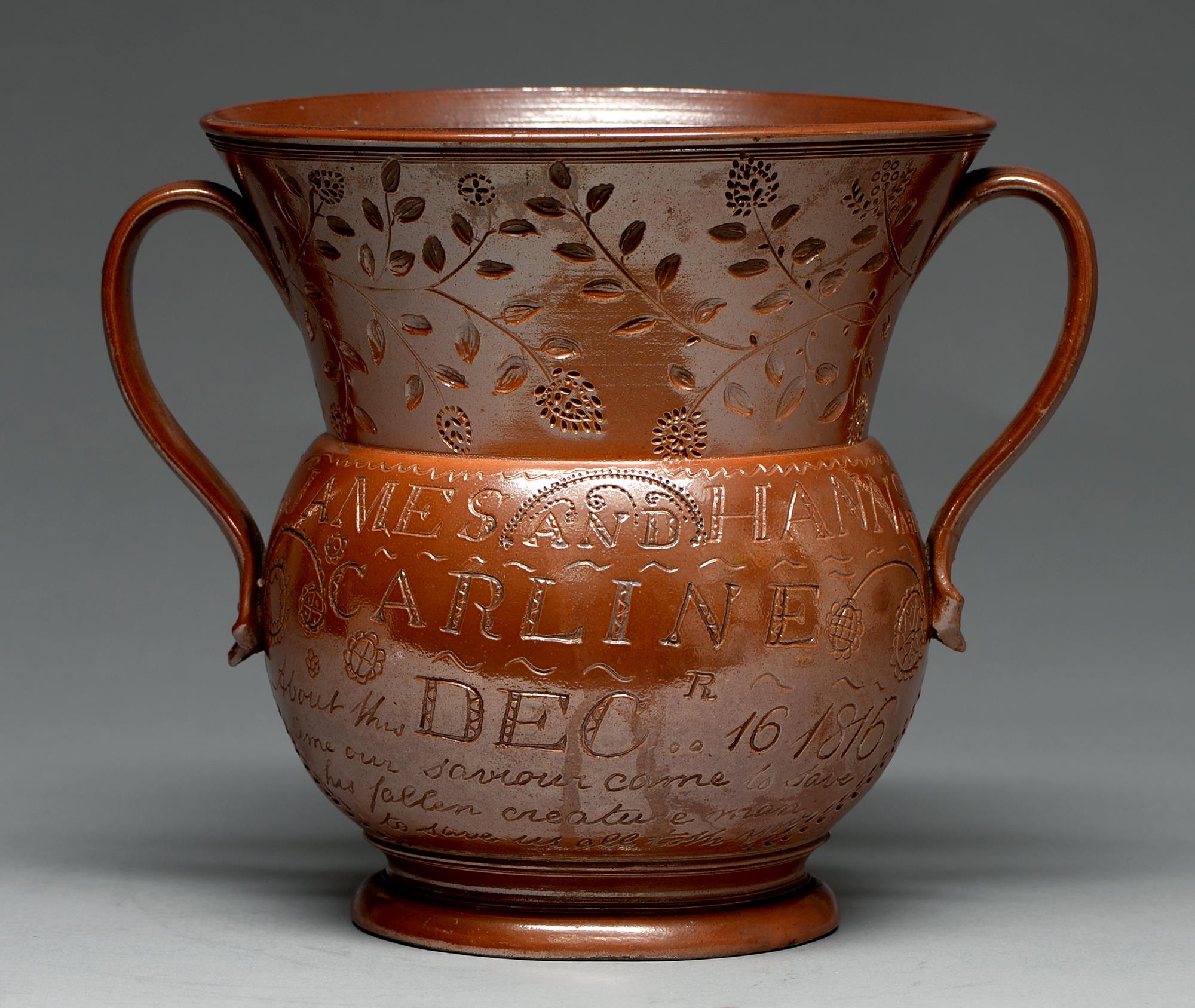 A Derbyshire saltglazed brown stoneware loving cup, Chesterfield, dated 1816, incised JAMES AND