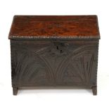 A Charles I boarded oak chest, 17th c, carved to the front with half lunettes in notched edges,