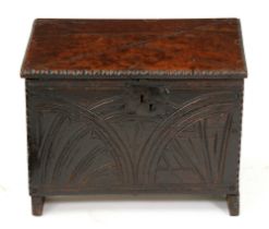 A Charles I boarded oak chest, 17th c, carved to the front with half lunettes in notched edges,
