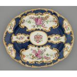 A Worcester scale blue ground dish, c1770, painted with flowers in gilt reserves and gilt feather