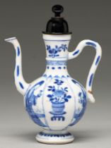 A Chinese moulded blue and white condiment ewer, Kangxi period, the lotus shaped panels and