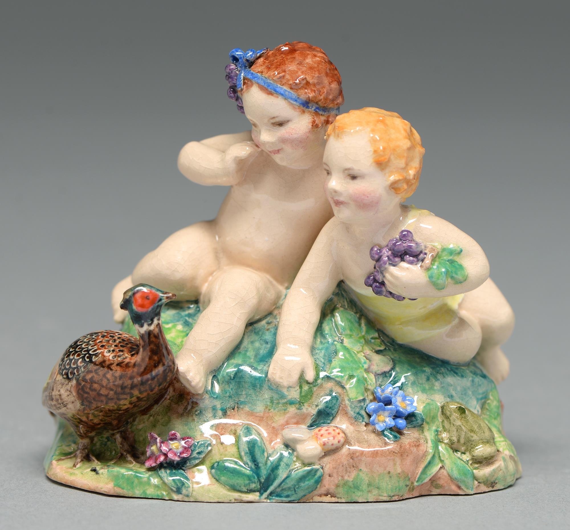 J S Bray and V Williams. A Dulwich Pottery group of two children and a pheasant, 1934, 75mm h,