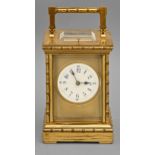 A French brass carriage clock, c1900, the enamel dial with blue chapters and blued steel hands,