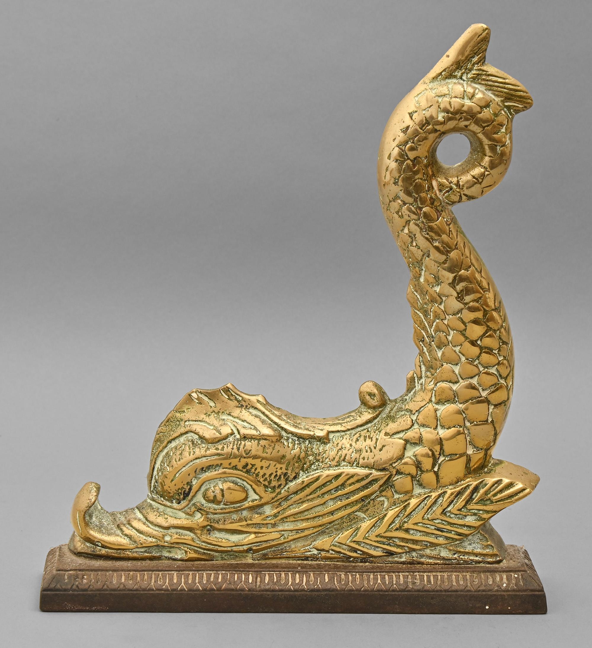 A Victorian brass door stop in the form of a dolphin, on cast iron base, 30cm h Polish residues,