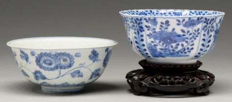 A Chinese blue and white fluted bowl, 18th c, painted to the well with two flowering plants